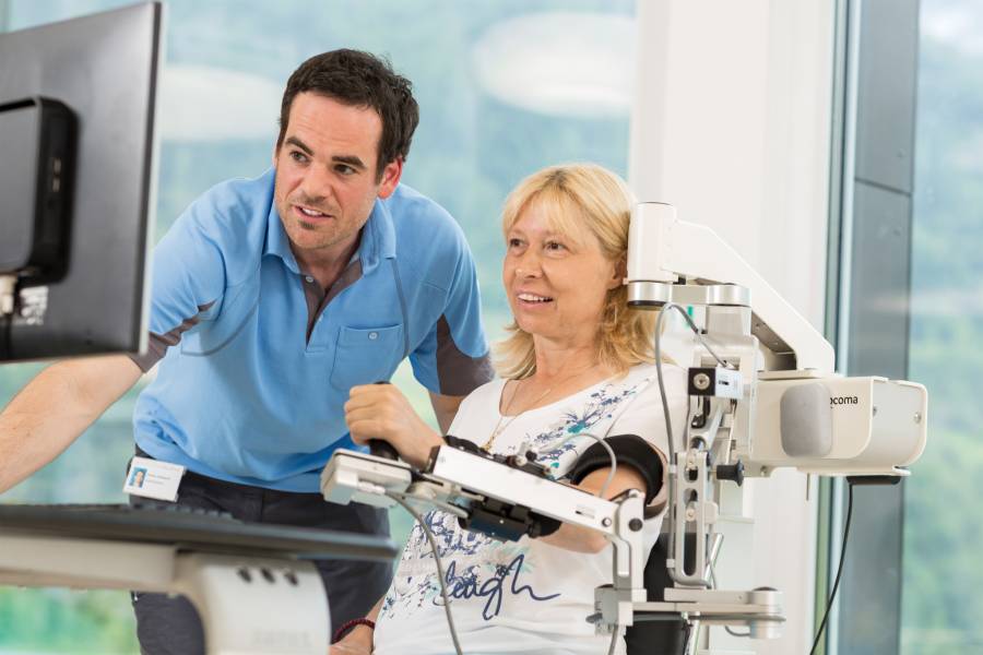 Patient exercising with the Armeo Spring arm and hand therapy system.